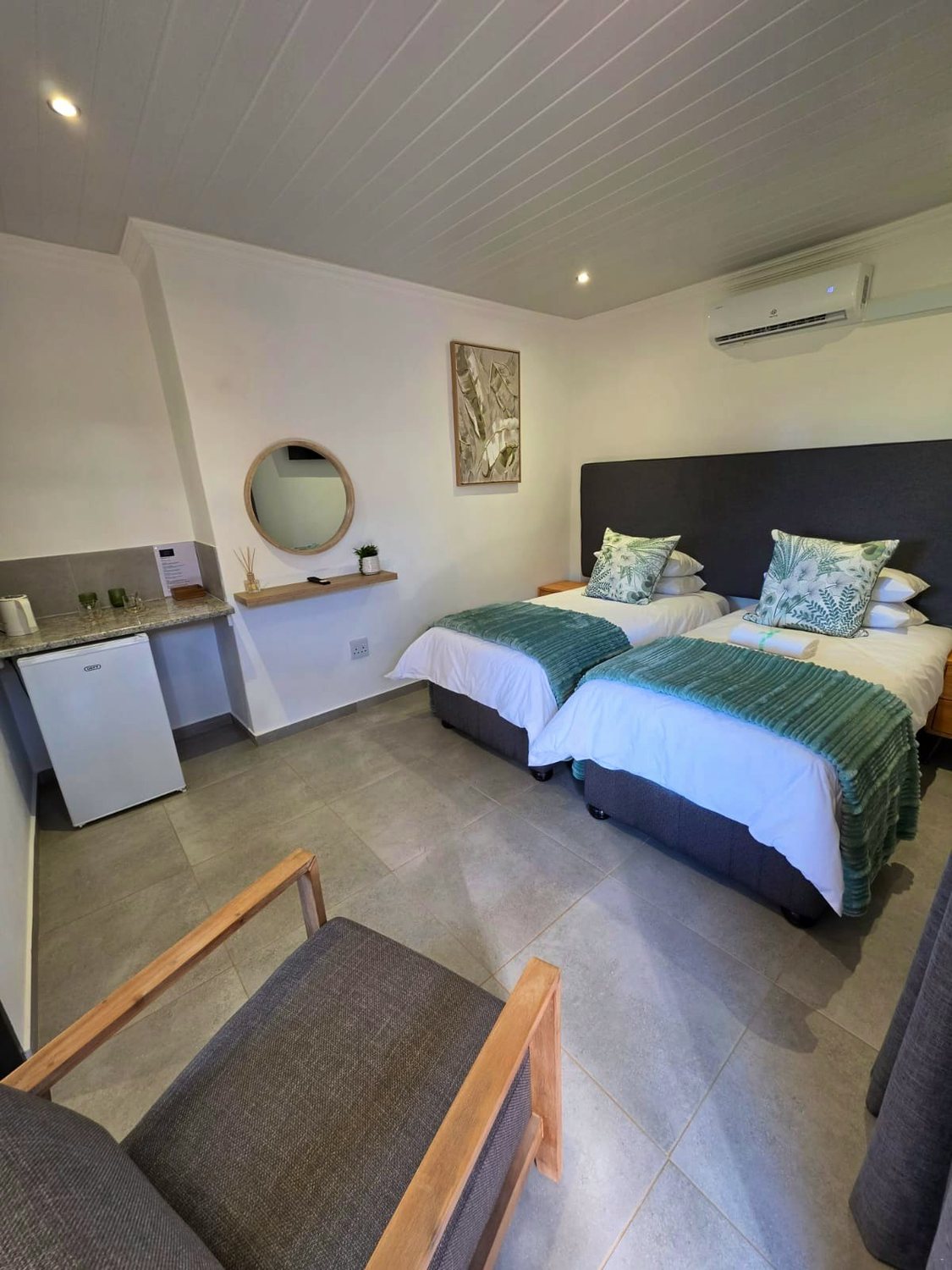 Room 2, two beds, with a fridge, tea station and armchair