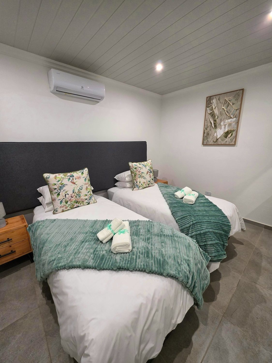 Room 3, two beds with sage green throws