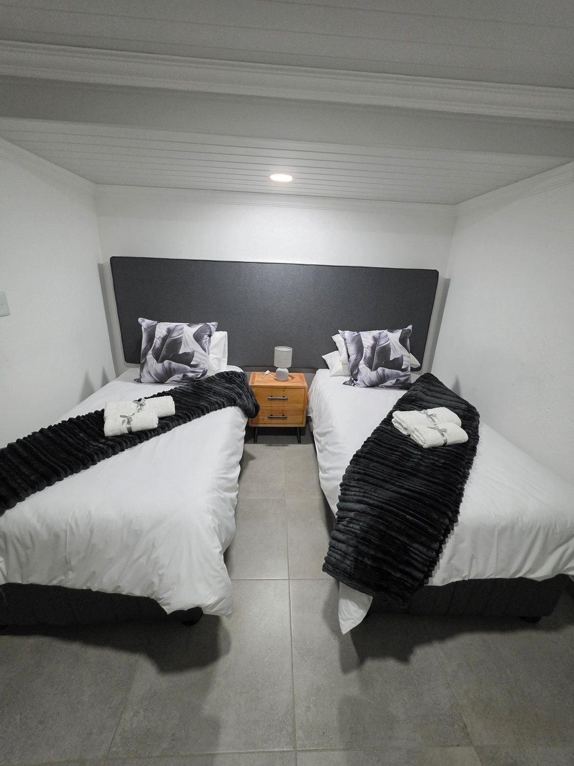 Room 5, two single beds with charcoal throws